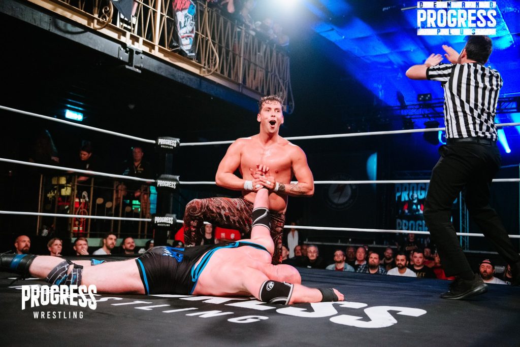 Tate Mayfairs wristlocks Simon Miller at PROGRESS Wrestling
