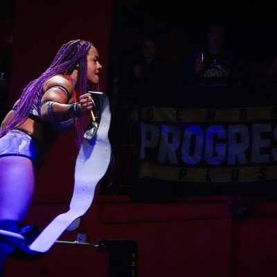 Rhio celebrates winning the PROGRESS Women's Championship